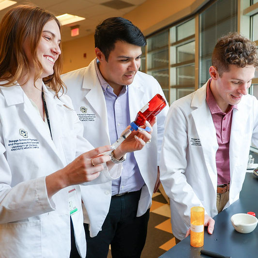 Students using a syringe in a lab