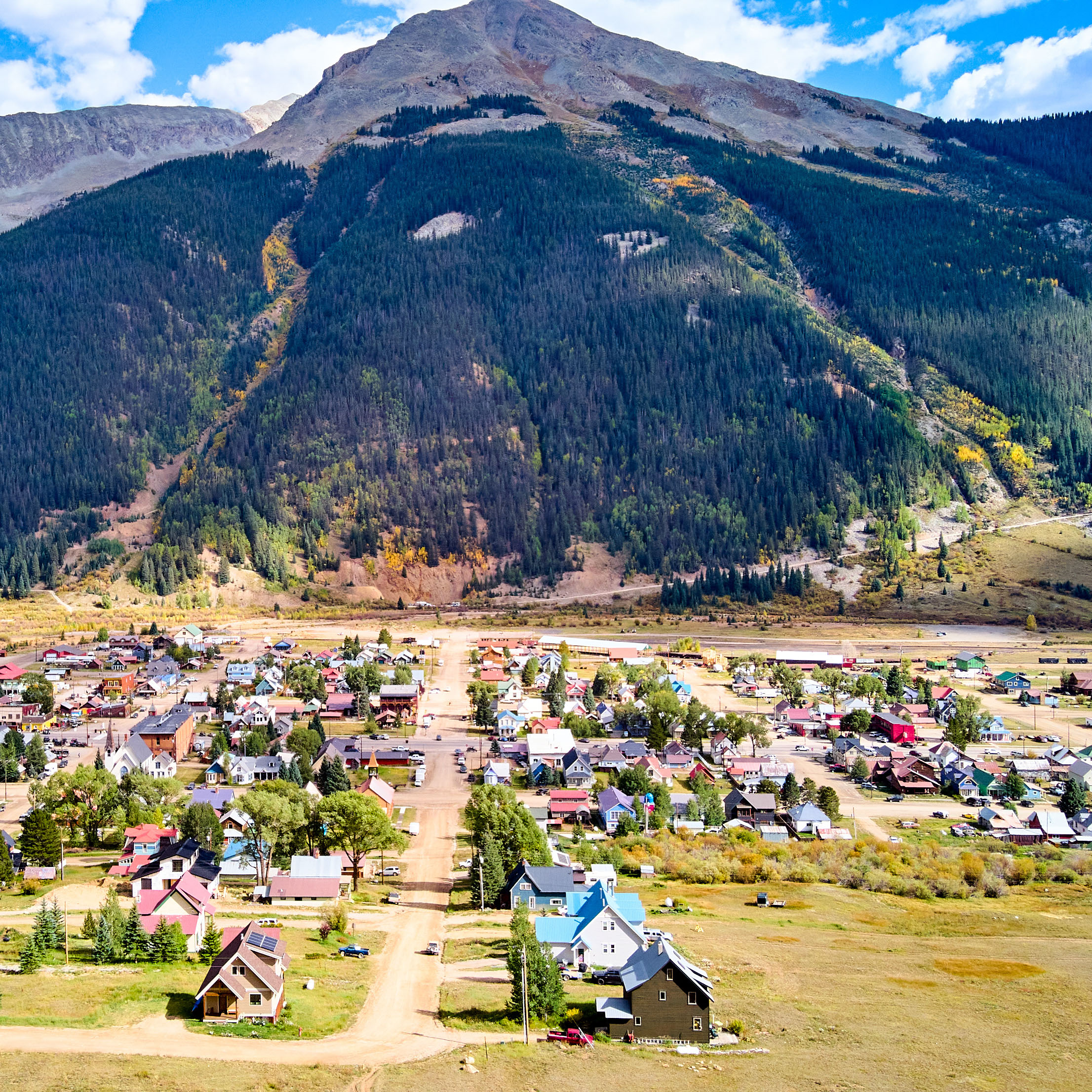 Mountain town with a dirt road 