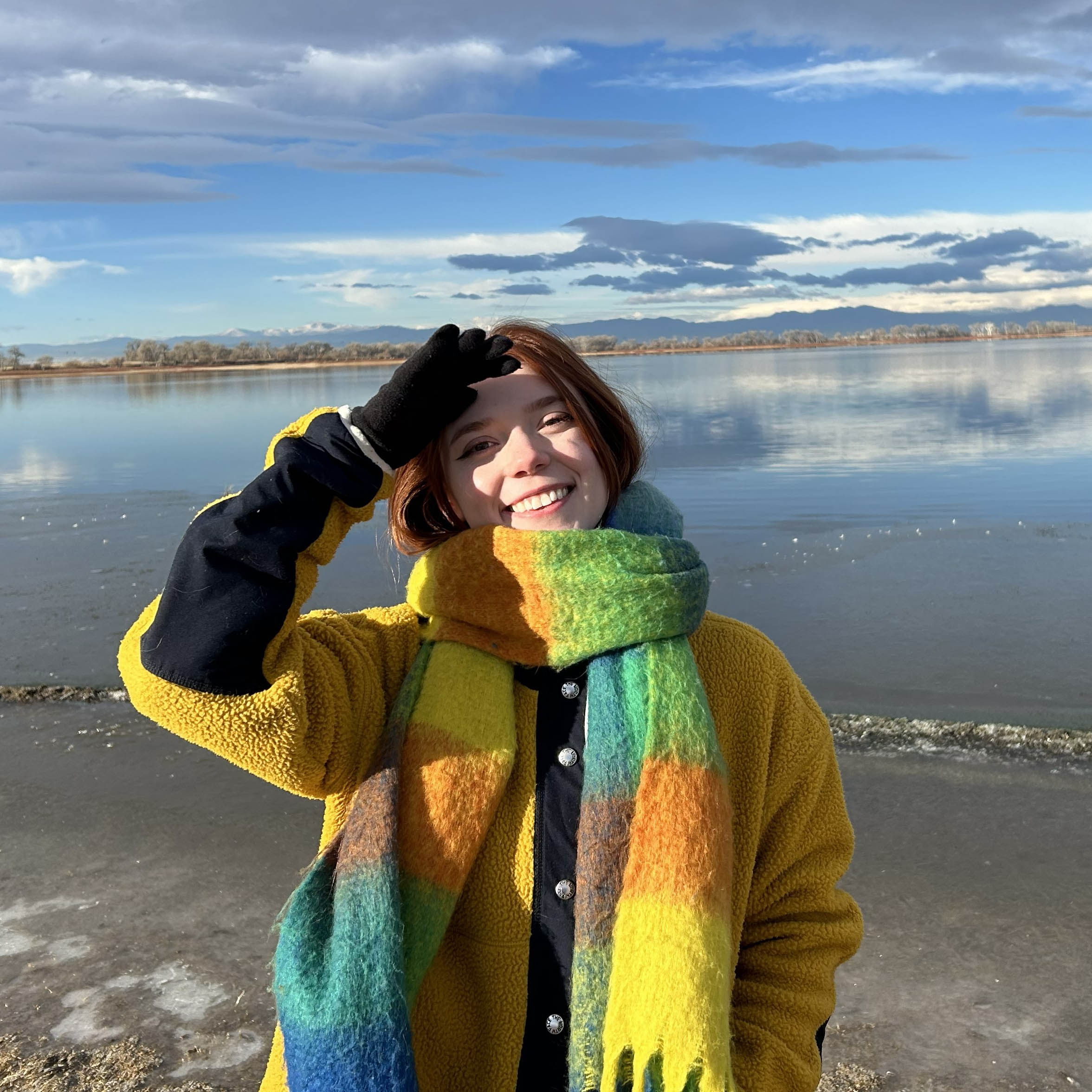 Woman wearing scarf at a large body of water