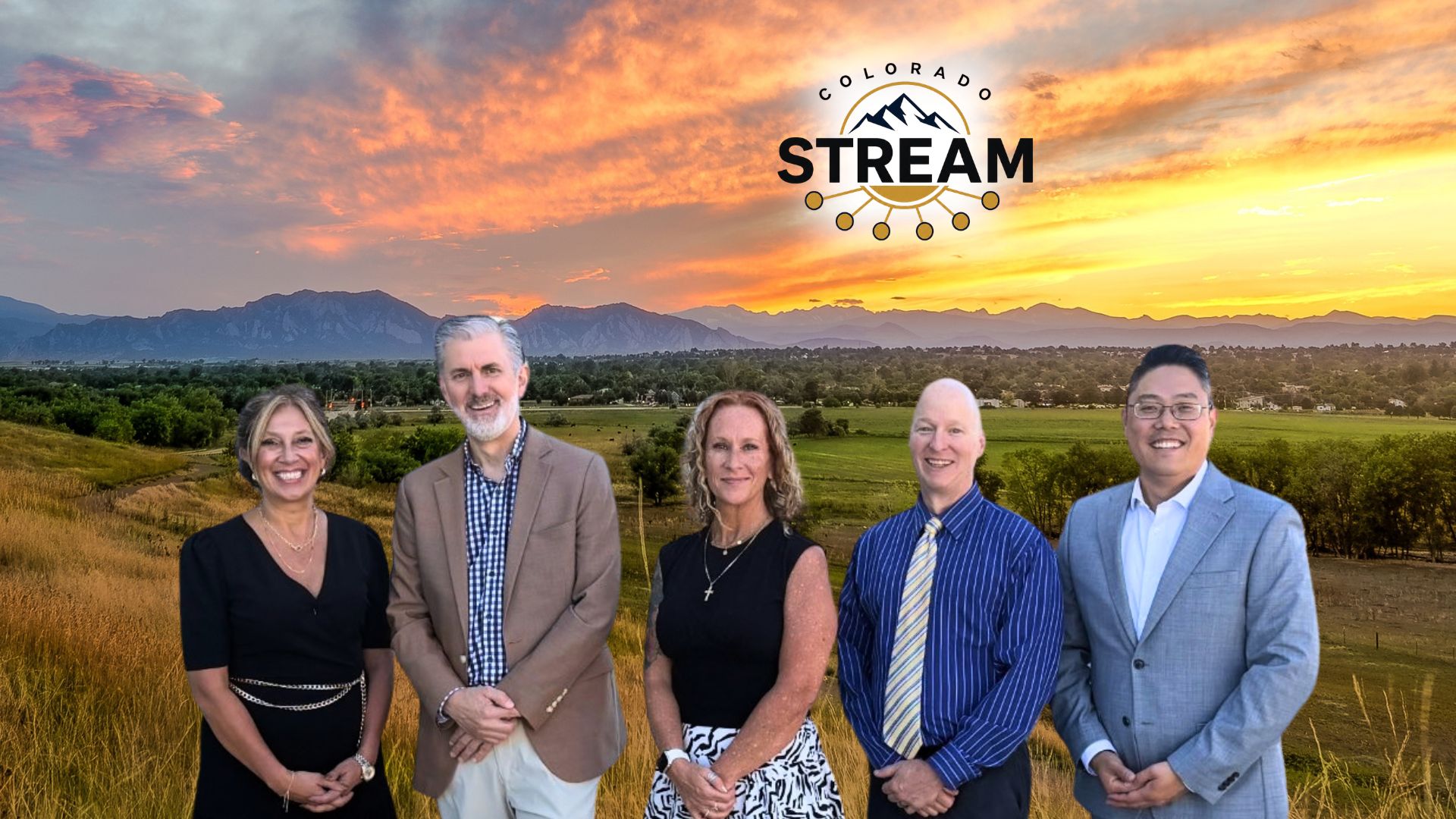 Group of people in front of sunset mountain range