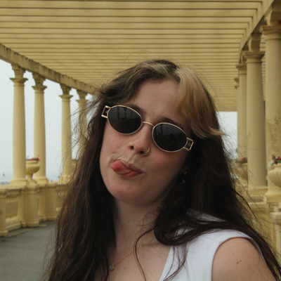 Girl sticking her tongue out wearing sunglasses 