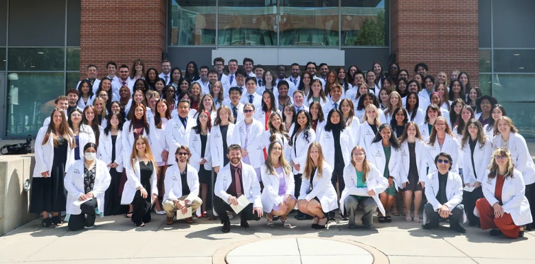 Class of 2030 group photo with their white coats