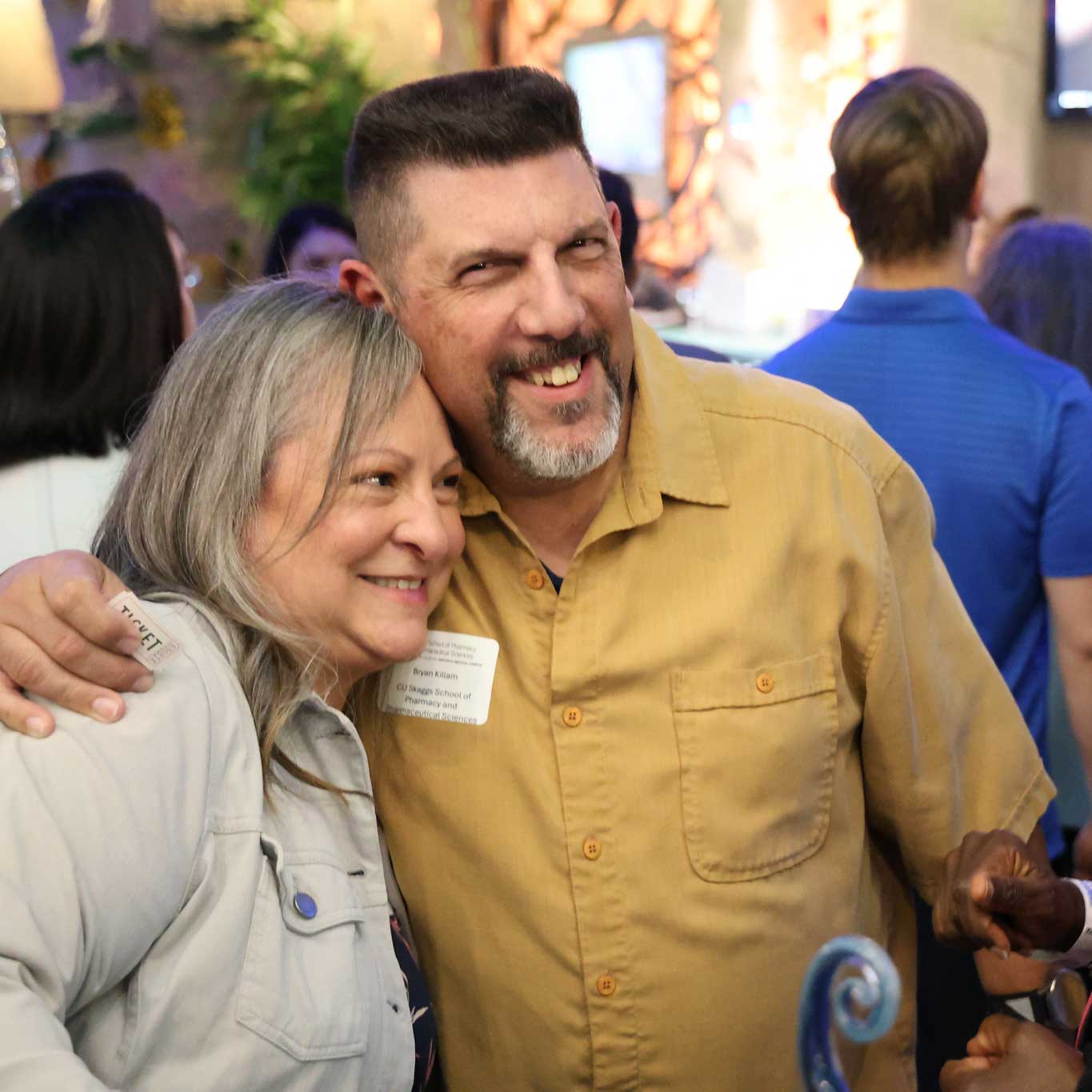 Man hugging woman on the shoulder